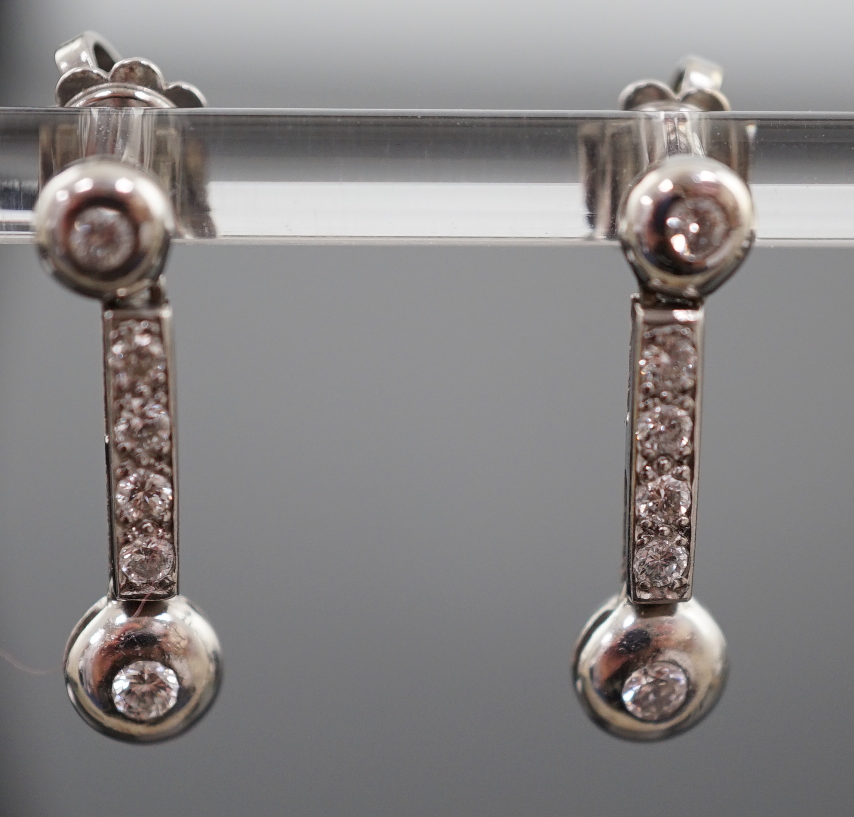 A modern pair of 18ct white gold and six stone diamond set line drop earrings